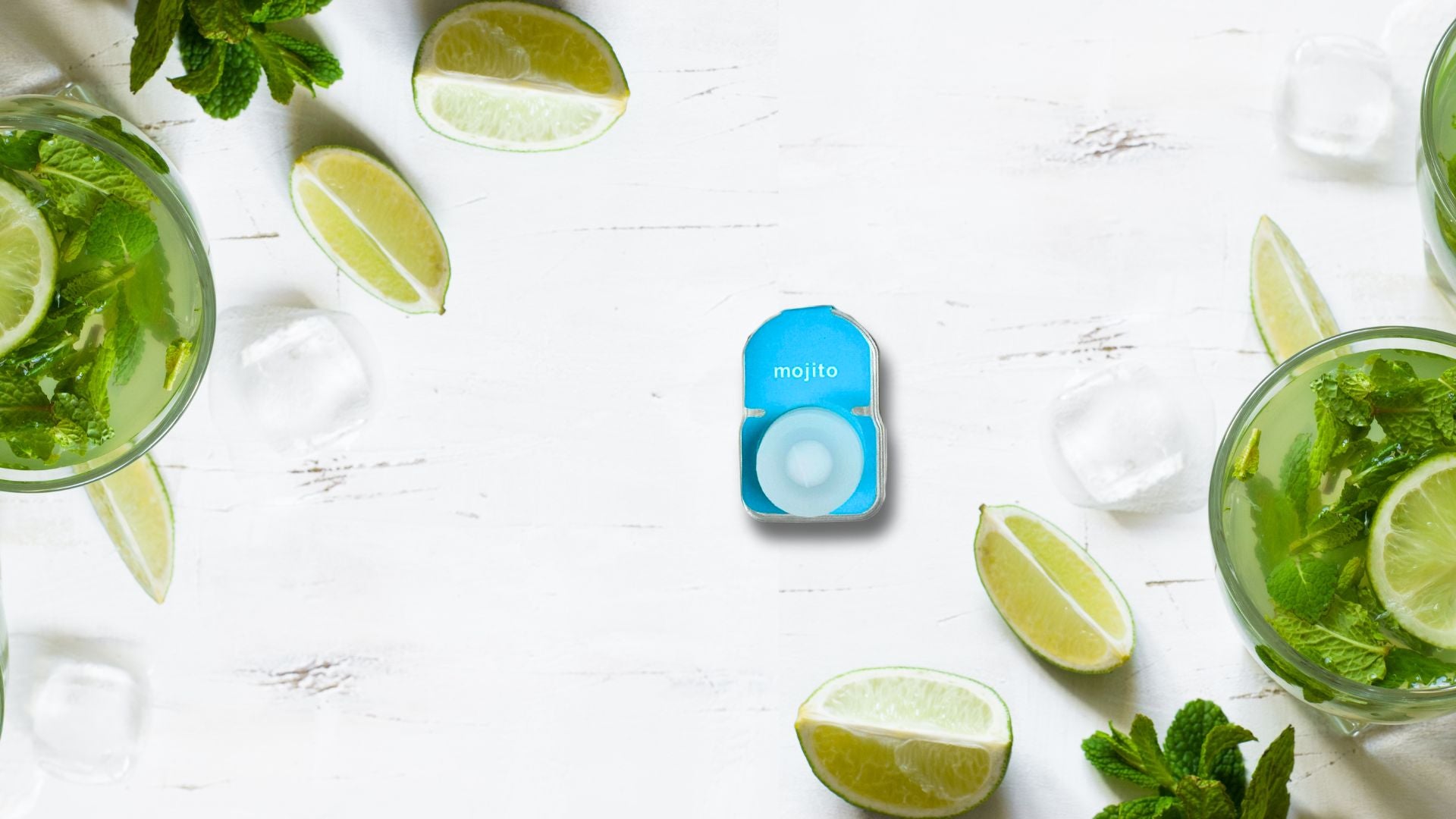 Mojito flavored Pod, resting on a table with ice, lemon, mint and a mojito cocktail