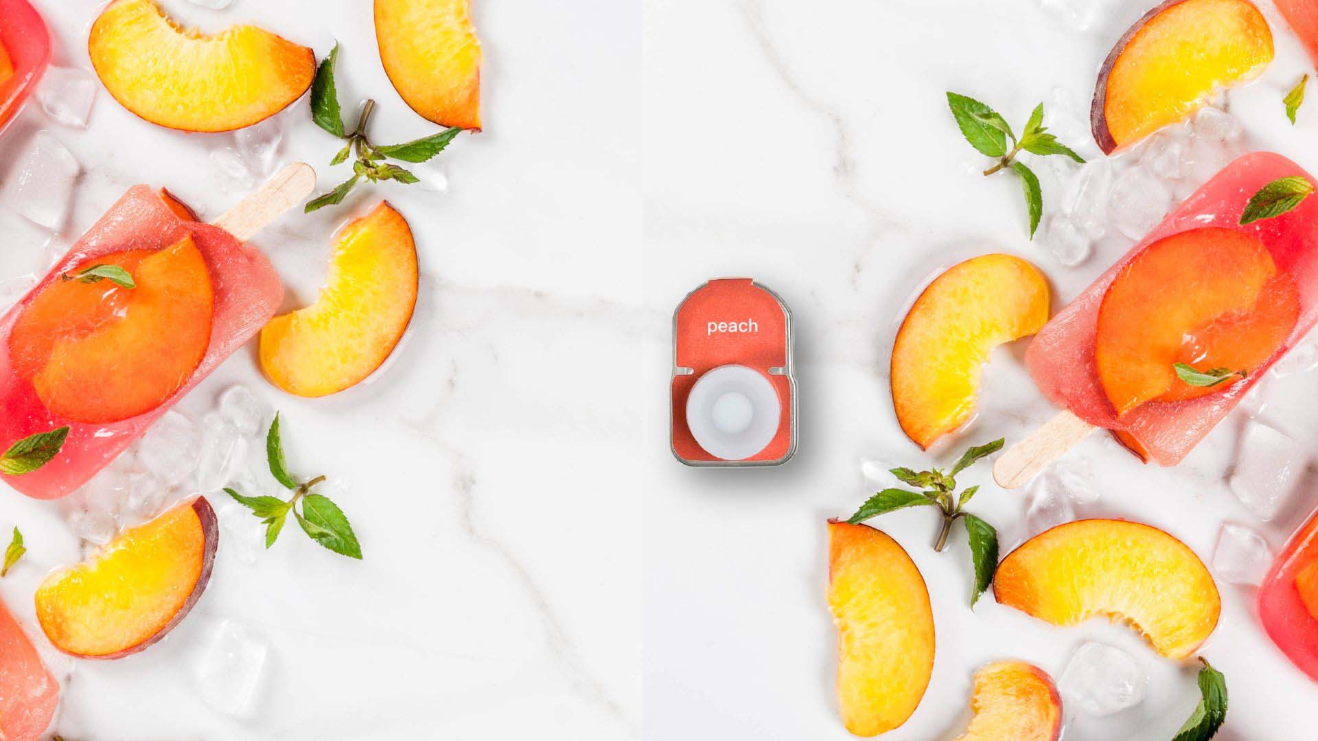 Wygle nano Peach Pod on a table with fresh peach slices and peach ice cream